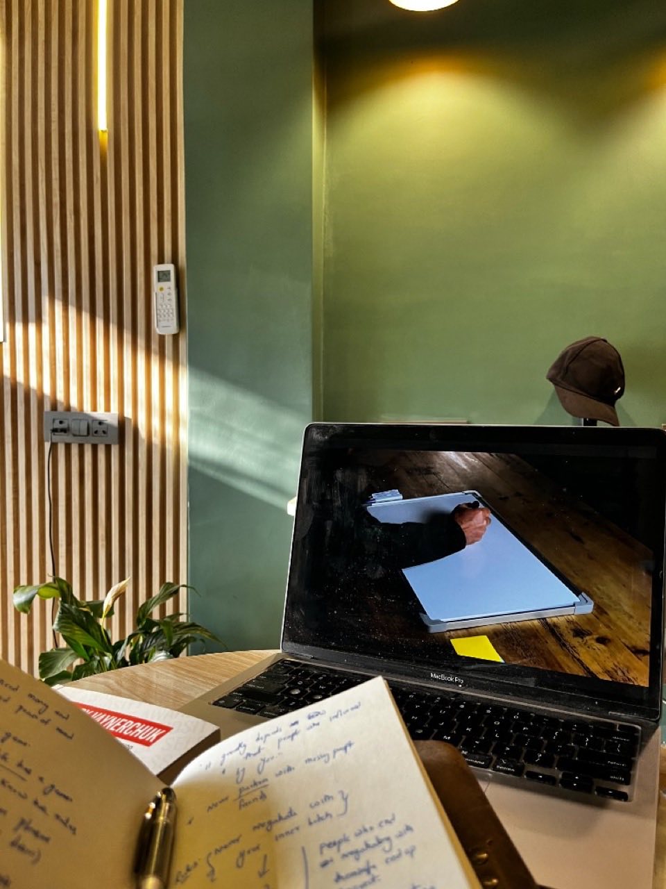 Work desk setup at SpaceIvy with laptop and notes